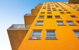 Image of a multi story building, looking towards the sky